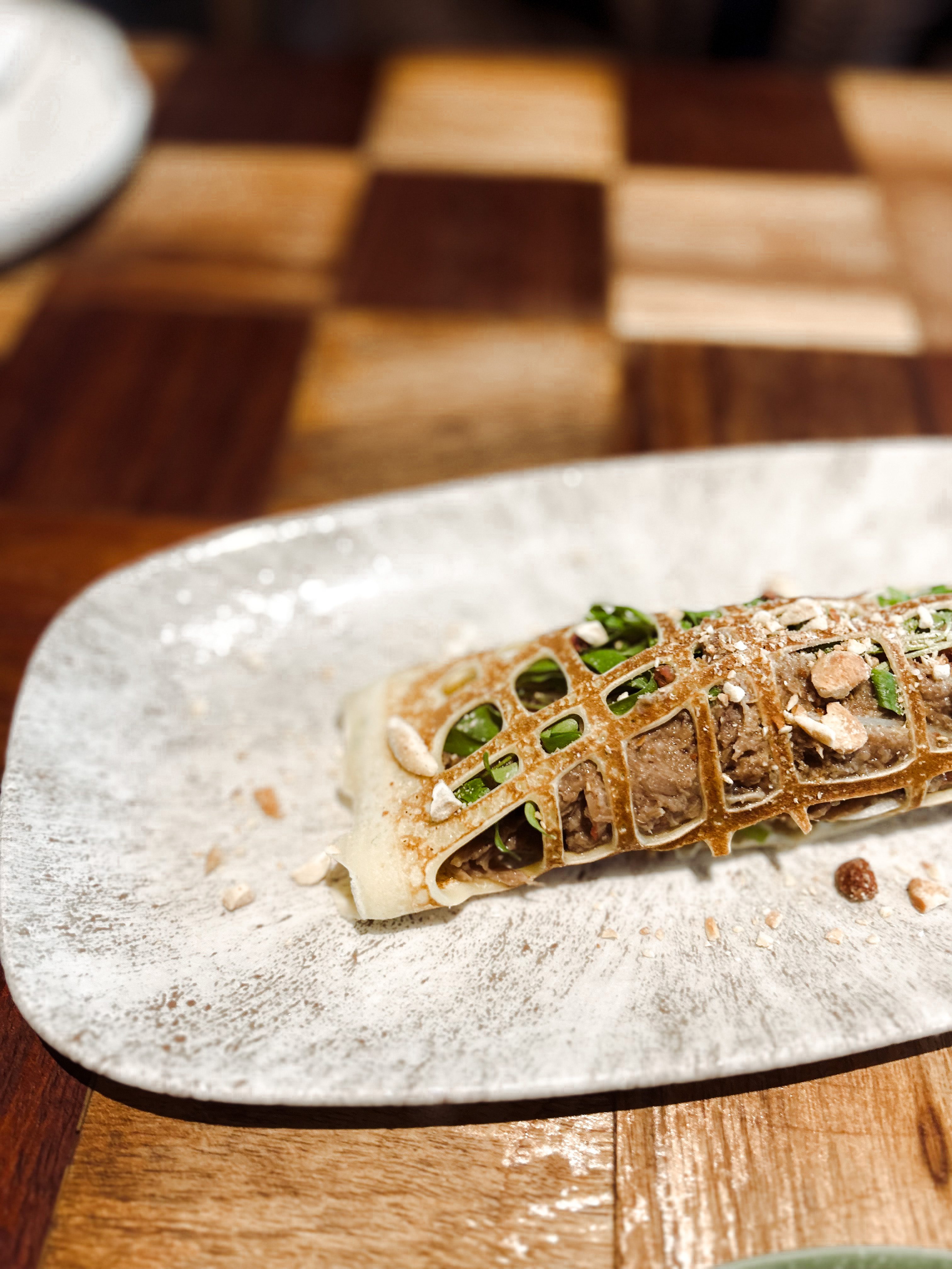 An appetizing serving of Pekin Duck Pancake, showcasing succulent duck meat and savory pancake, served at Pink Valley Wine Farm.