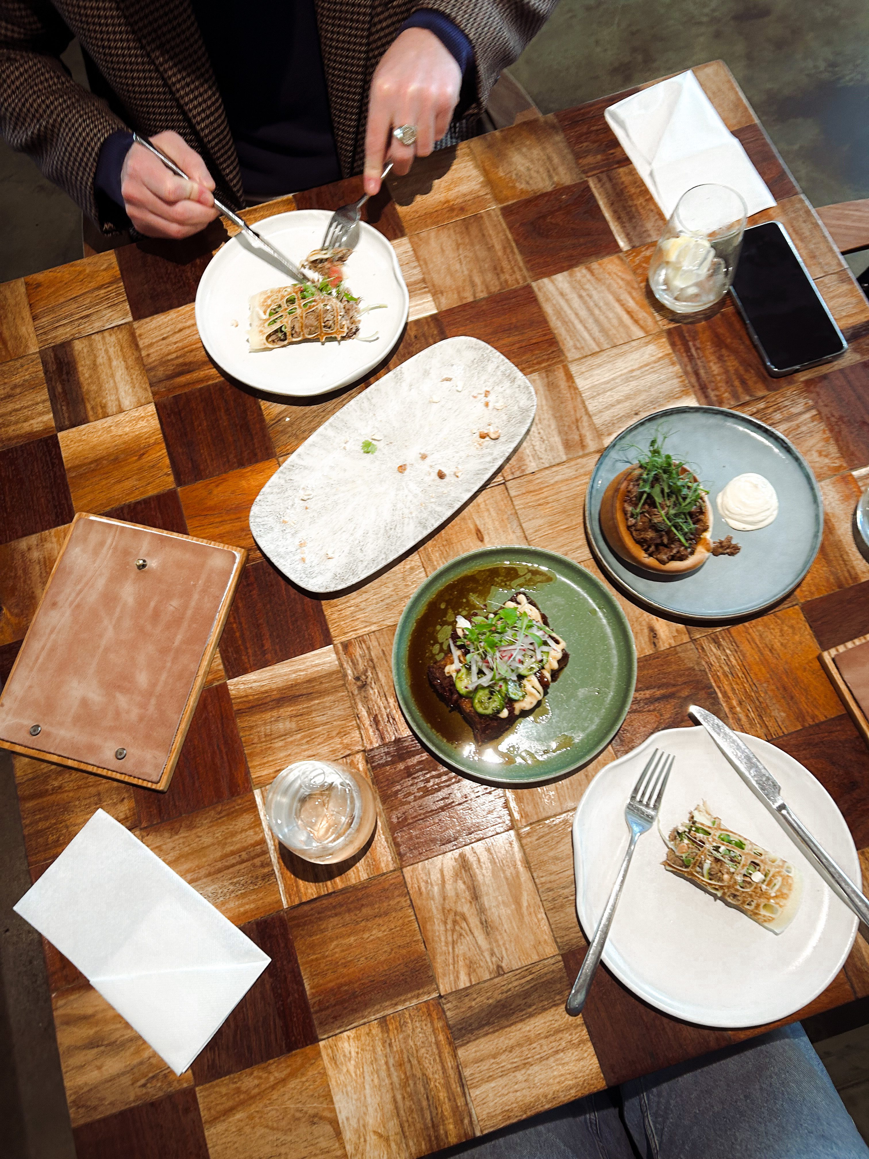 A captivating view of a table adorned with a delightful spread of mouthwatering dishes at Pink Valley Wine Farm, invitingly arranged and ready to be savored